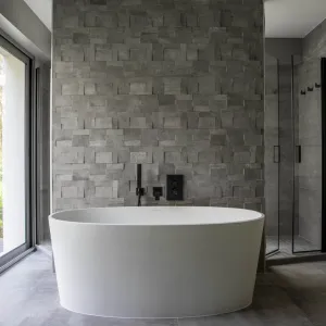 Vignette La salle de bains sur fond de pierre avec un baignoire cuvette et robinetterie noire